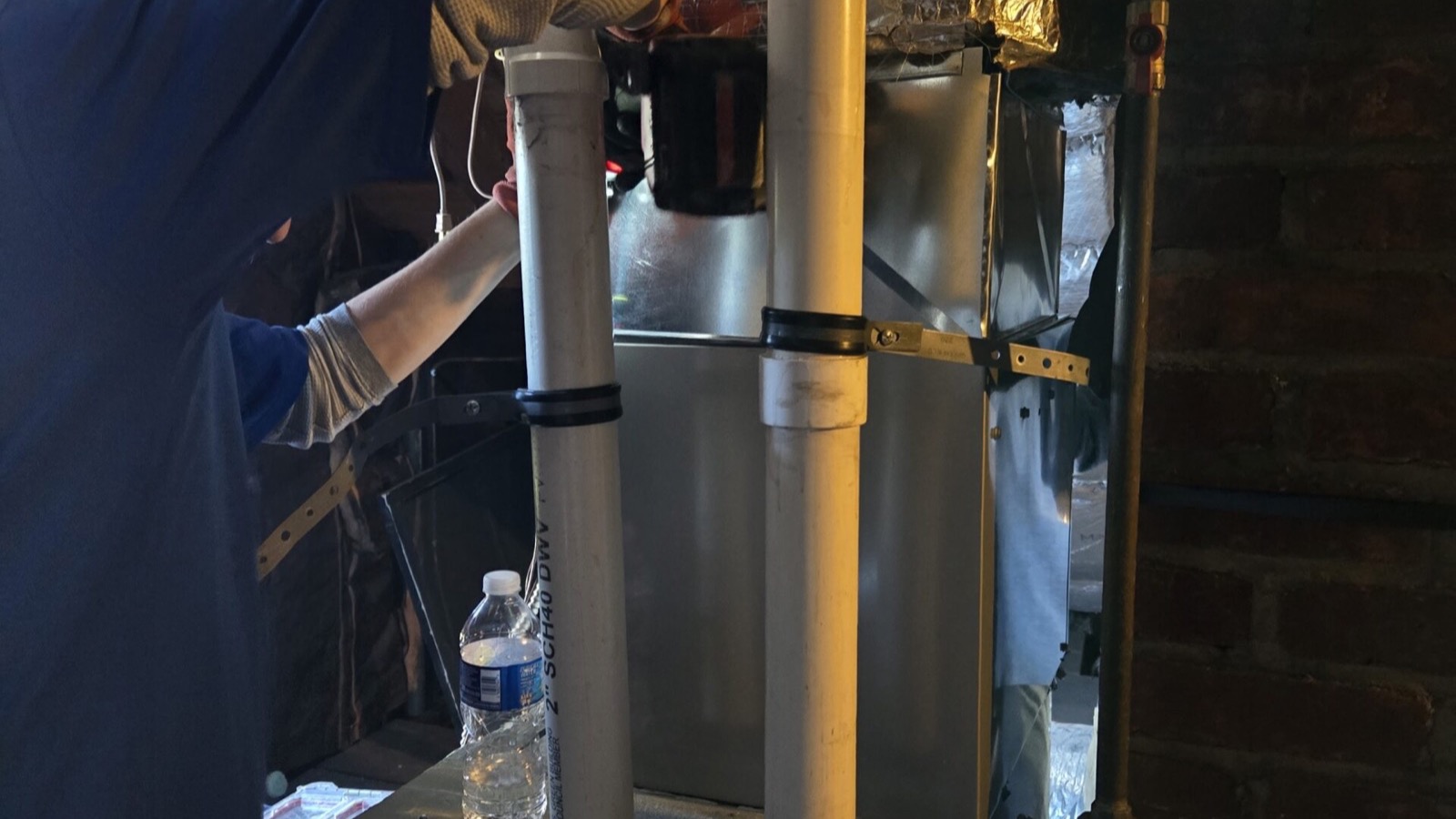 Technician servicing an indoor furnace